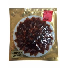 Iberian acorn-fed ham cut by knife and vacuum packed.