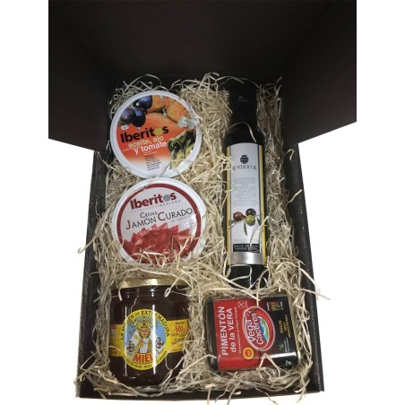 Small gift box with oil, cured ham, honey, paprika and tin oil, garlic and tomato for Christmas