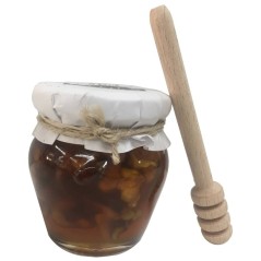 Honey jar with walnuts and tasting stick for events and celebrations