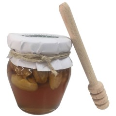 Little jar of honey with almonds and stick taster for events