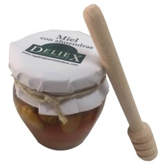 Little jar of honey with almonds and stick taster for events